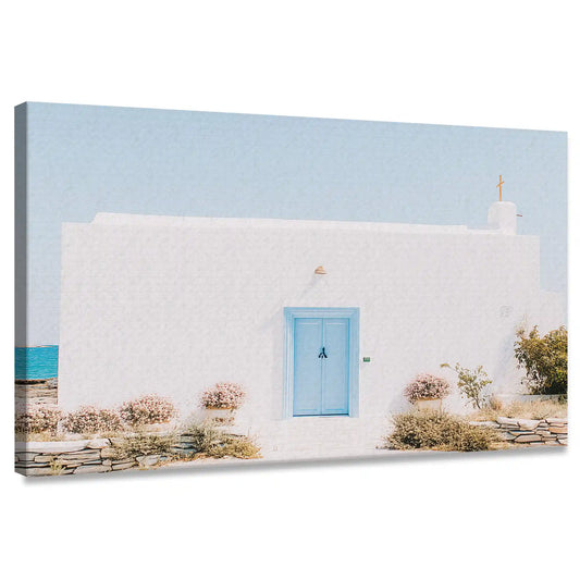 Blue door on white coastal home — coastal canvas wall art with minimalist tones, calming Mediterranean decor for modern living room spaces