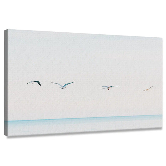 Minimalist seagulls over ocean coastal canvas print for living room — soft pastel tones evoke peaceful seaside calm and openness.