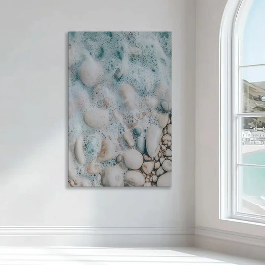 Smooth beach stones — modern canvas wall art, tranquil ocean foam and soft beige palette enhance minimalist coastal interiors.
