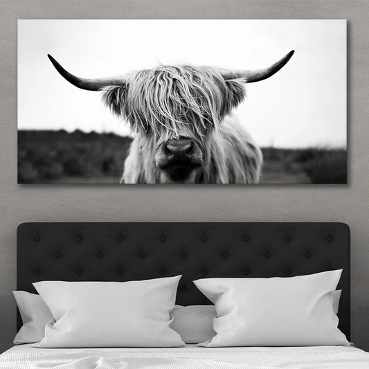 Large Highland cow canvas wall art over bed in neutral farmhouse bedroom interior