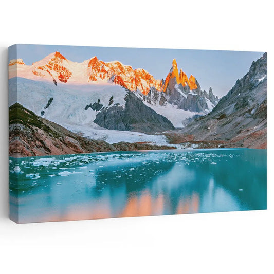 Patagonia mountain peaks canvas wall art for living room décor bringing a peaceful sunrise mood with glowing orange light over icy blue waters