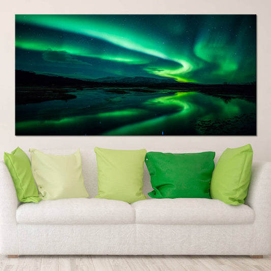 Abstract aurora swirl above dark mountains — large canvas wall art with vivid green palette creating a dramatic focal point for bedroom decor.