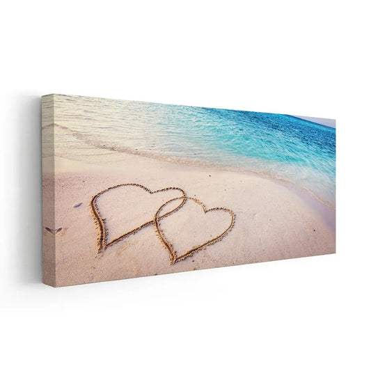 Two sand hearts — large canvas wall art with ocean waves and beige tones, romantic coastal décor perfect for serene bedroom interiors.