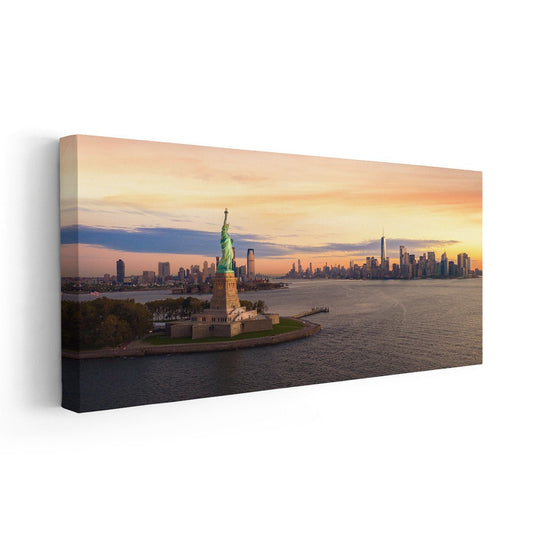 Liberty statue at dusk — modern canvas wall art with glowing skyline and soft amber tones, peaceful and uplifting bedroom wall accent.