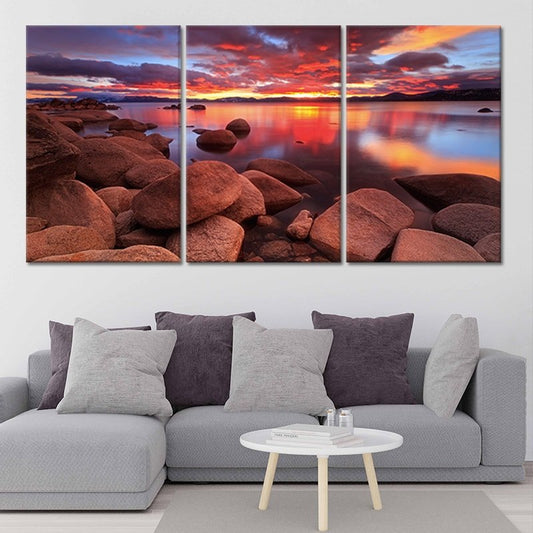 Fiery lake sunset over rocky shoreline Large canvas art adding a peaceful bedroom mood with rich orange hues and tranquil evening scenery