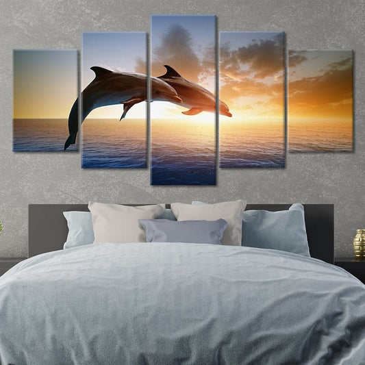 Leaping dolphins over ocean — large canvas wall art in warm sunset tones, perfect for beach house or modern seaside decor.