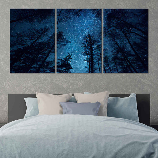 Blue night forest sky canvas wall art for bedroom décor creating a calming celestial atmosphere with rich deep-blue tones above the treetops
