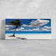 Coastal beach wall art with a vibrant palm tree and turquoise water.