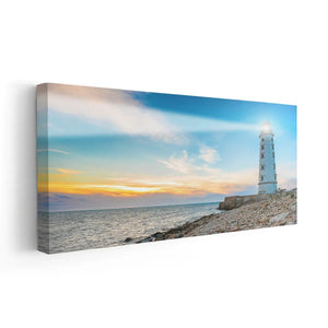 Modern ocean art with a tall lighthouse against a colorful horizon.