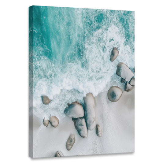 Aerial beach canvas wall art for bedroom featuring turquoise waves over soft sandy shore with rocks