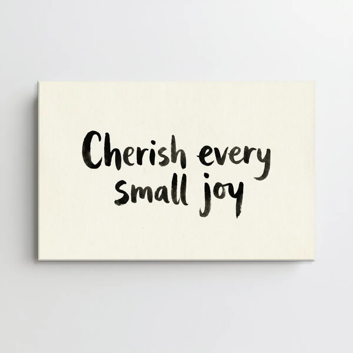 Simple canvas wall art with brush-style lettering and a centered inspirational quote on a plain background