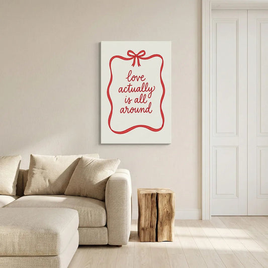 Canvas wall art with elegant red ribbon forming a rectangle and bow above romantic hand-lettered quote on white canvas
