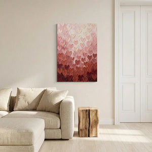 Textured canvas wall art with repeating hearts in peach, cream, and burgundy forming a soft, romantic gradient design