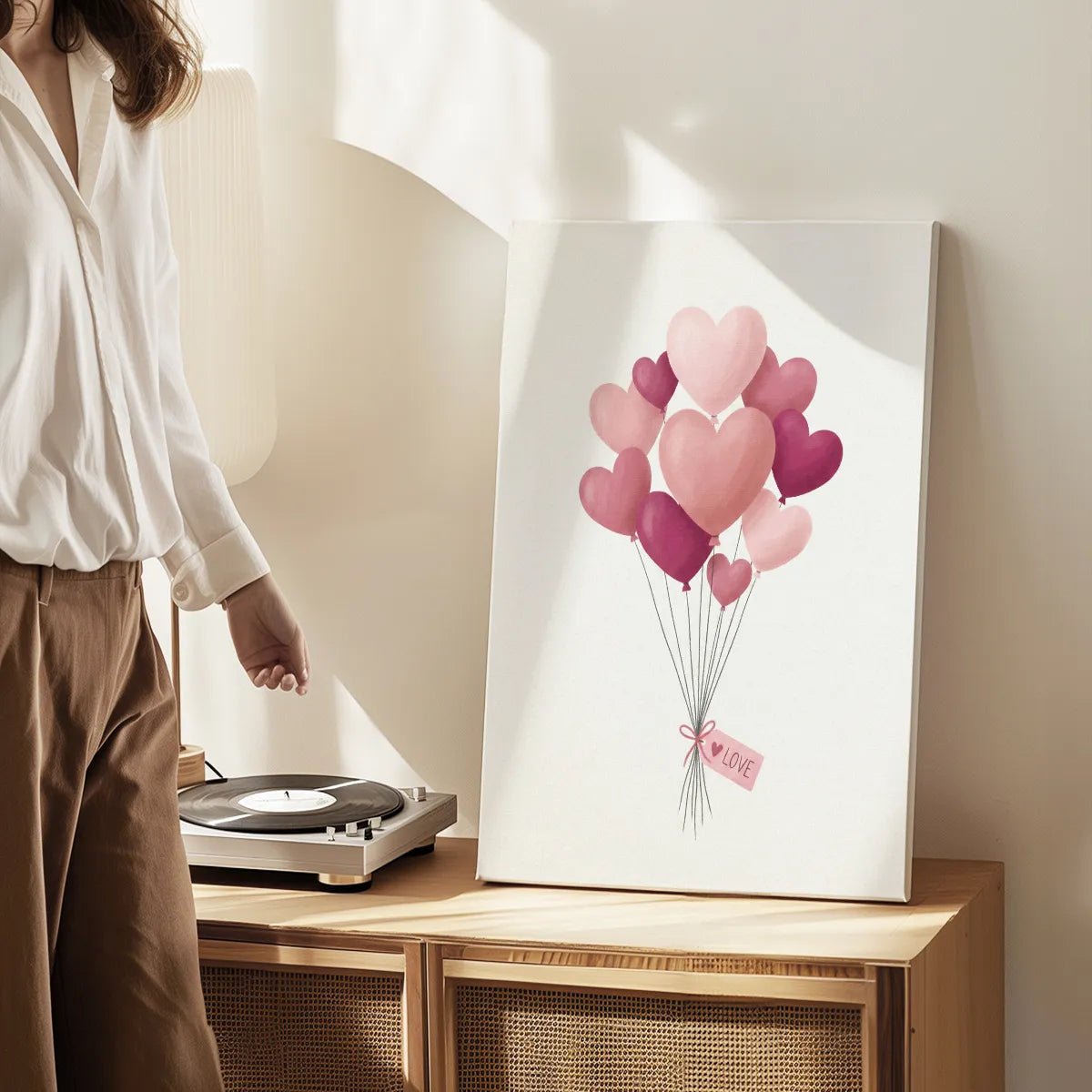 Canvas wall art print with a soft, affectionate mood, featuring heart balloons tied with ribbon and a LOVE tag in the center.