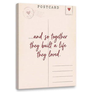 Minimalist canvas wall art featuring a vintage postcard design with a heart, stamp, and the quote '...and so together they built a life they loved.'