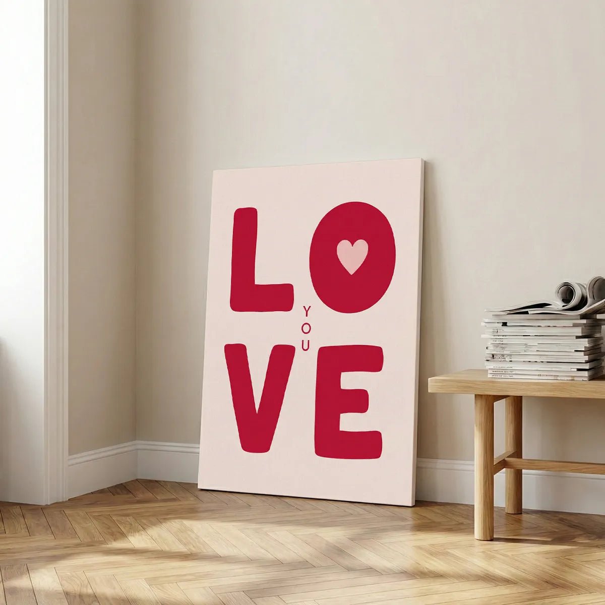 Modern canvas art showcasing graphic red lettering and a heart symbol, combining minimalist and pop art styles