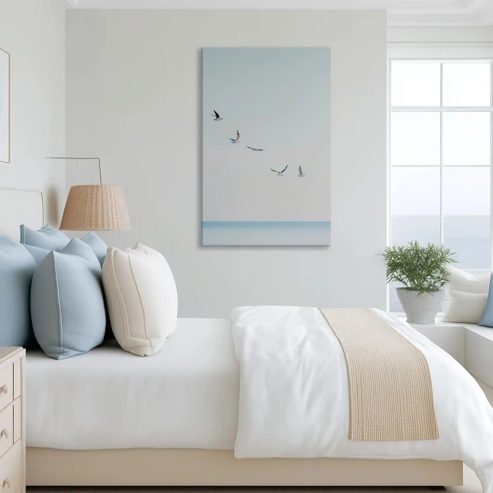 Soft pastel gulls canvas art complementing Scandinavian inspired white and airy dining space