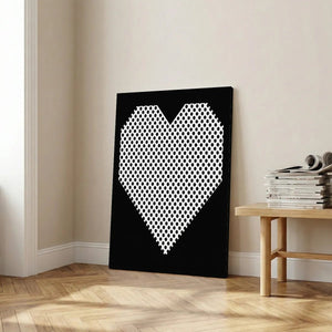 Pop art canvas wall art with a minimalist black and white heart design composed of polka dots on a high-contrast background