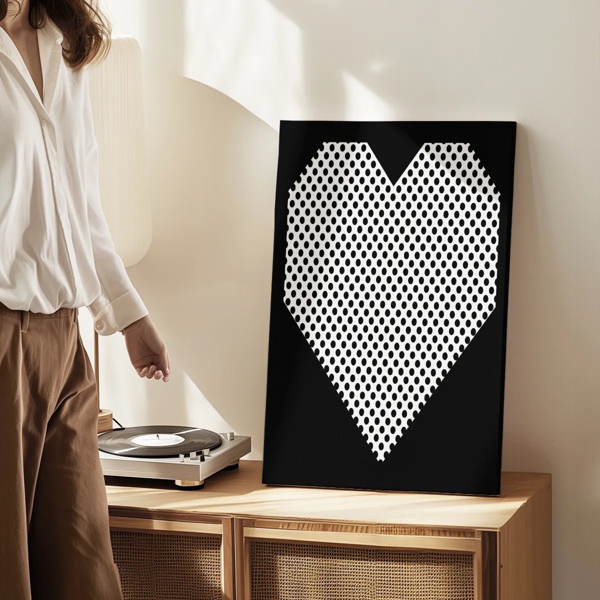 Canvas wall art print of a geometric heart with polka dots, designed in a clean pop art style for modern decor settings