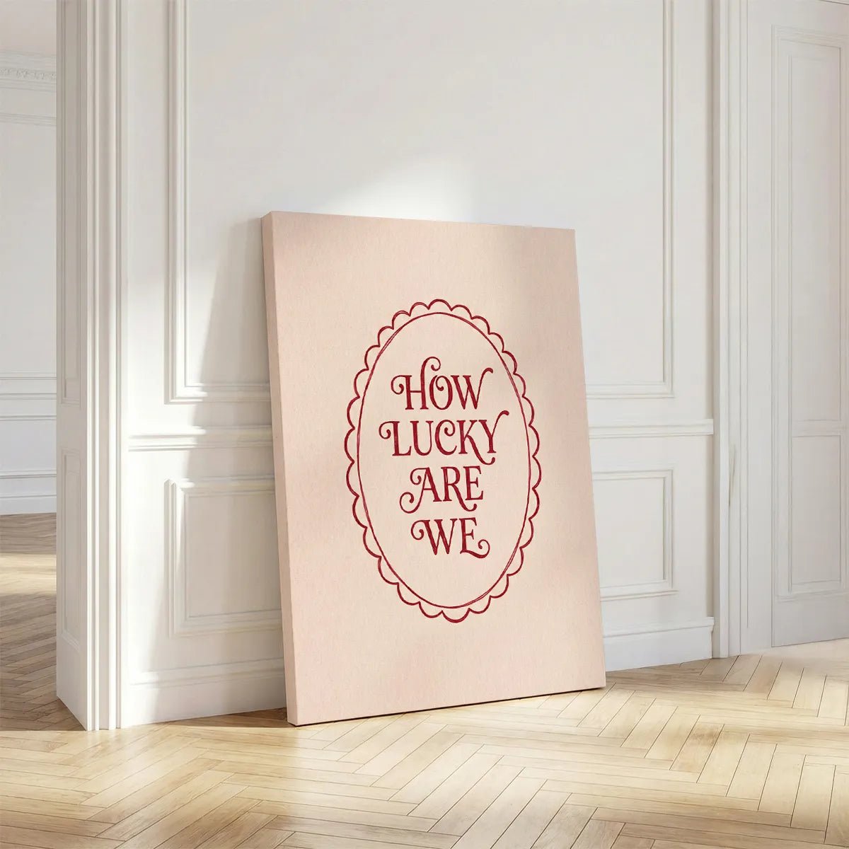 Clean-lined canvas artwork displaying sentimental red text inside a vintage oval motif on a soft beige canvas