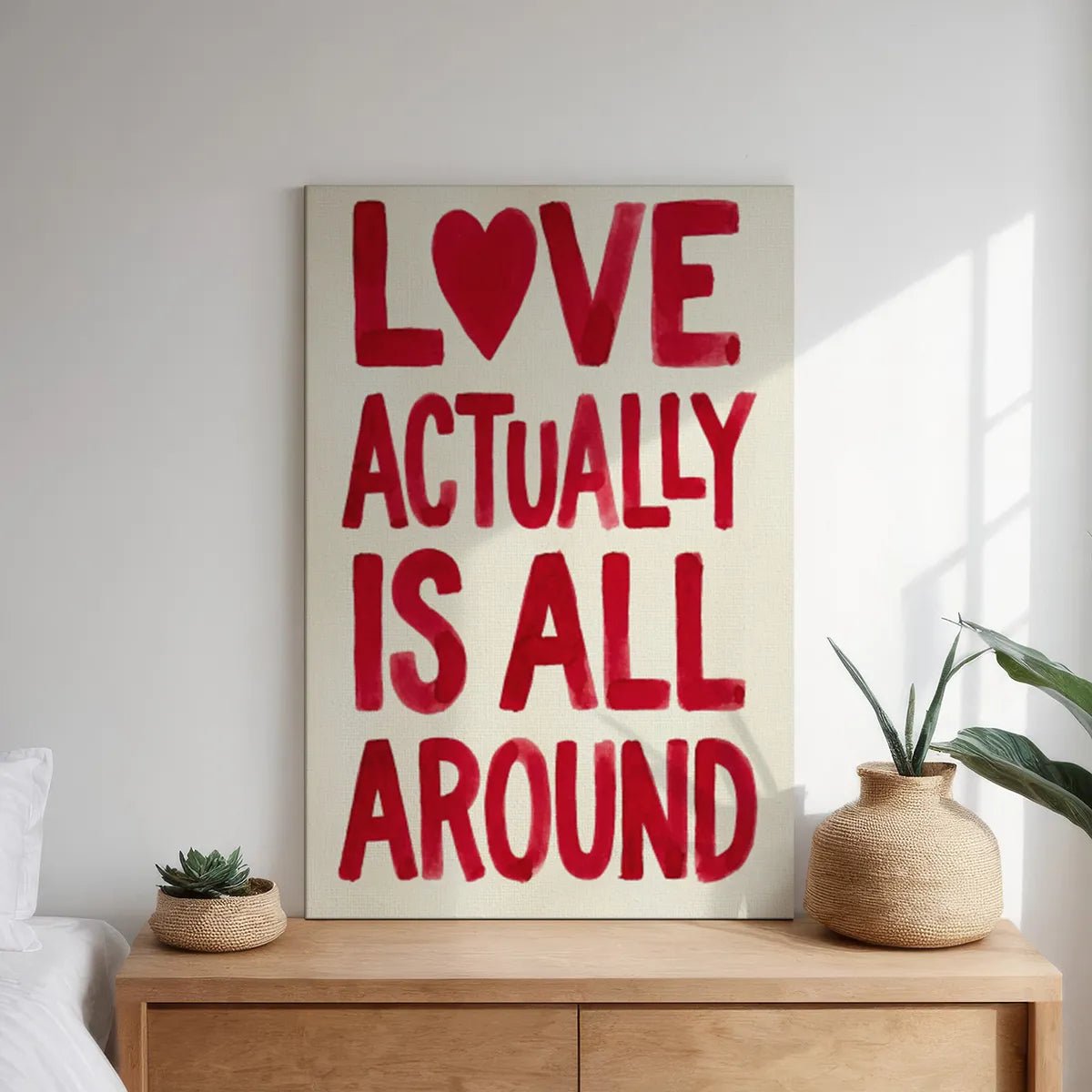 Canvas wall art print with high-contrast red text and heart symbol, styled for romantic spaces like bedrooms or lounges.