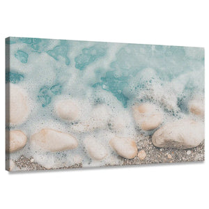 Turquoise coastal canvas wall art with foamy waves over sandy rocks for living room décor