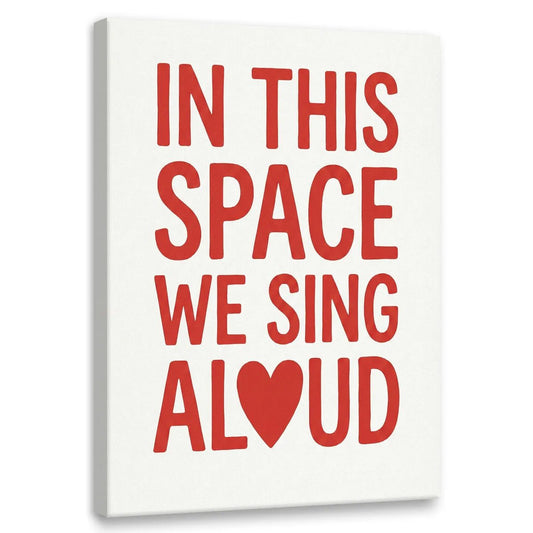 Modern canvas wall art featuring bold red text 'IN THIS SPACE WE SING ALOUD' with a heart symbol replacing the 'O' in 'ALOUD'.