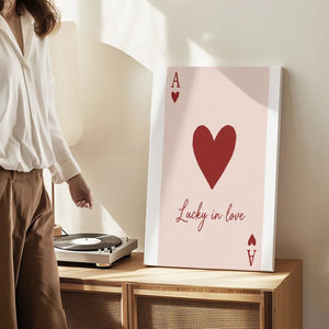 Vertical canvas art with a central red heart, bold letter A, and elegant cursive text conveying a playful romantic tone.
