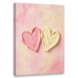 Abstract canvas wall art featuring two overlapping hearts in pink and cream on a textured pastel background with impasto brushwork.