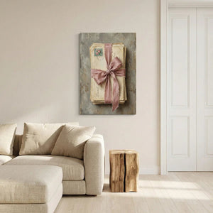 Canvas wall decor with a centered bundle of vintage letters tied in pink ribbon, evoking a sentimental and intimate mood.