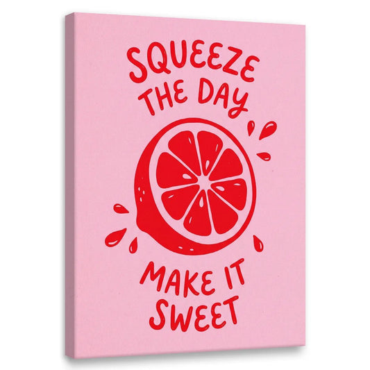 Bold pop art canvas wall art featuring a red citrus slice with juice droplets and the phrase 'Squeeze the Day Make It Sweet'.