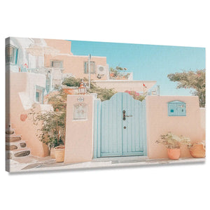 Coastal canvas wall art of pastel Mediterranean houses with aqua doors and terracotta walls