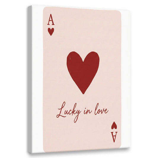 Minimalist canvas wall art featuring a red heart, letter A, and 'Lucky in love' in cursive on a soft pink background.