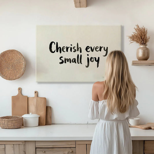 Minimalist canvas wall art with centered black lettering that reads 'Cherish every small joy' on a neutral background