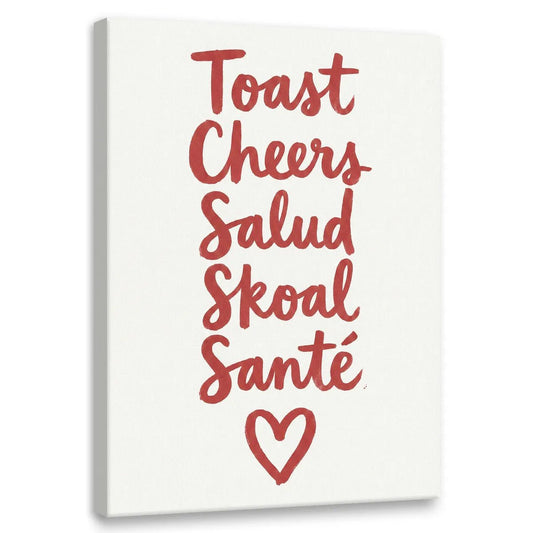 Modern canvas wall art featuring red handwritten words 'Toast, Cheers, Salud, Skoal, Santé' stacked vertically with a heart symbol below.