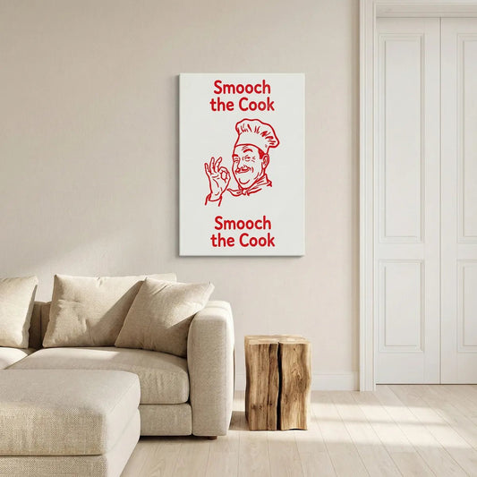 Playful canvas wall art showing a smiling chef in bold line art with red and white tones and the phrase 'Smooch the Cook'.