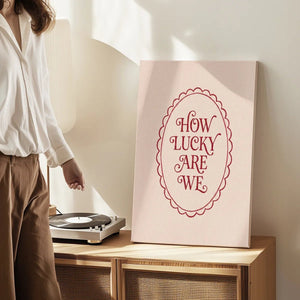 Gallery wrapped canvas featuring affectionate message in clean red font, framed by a scalloped oval on a beige field
