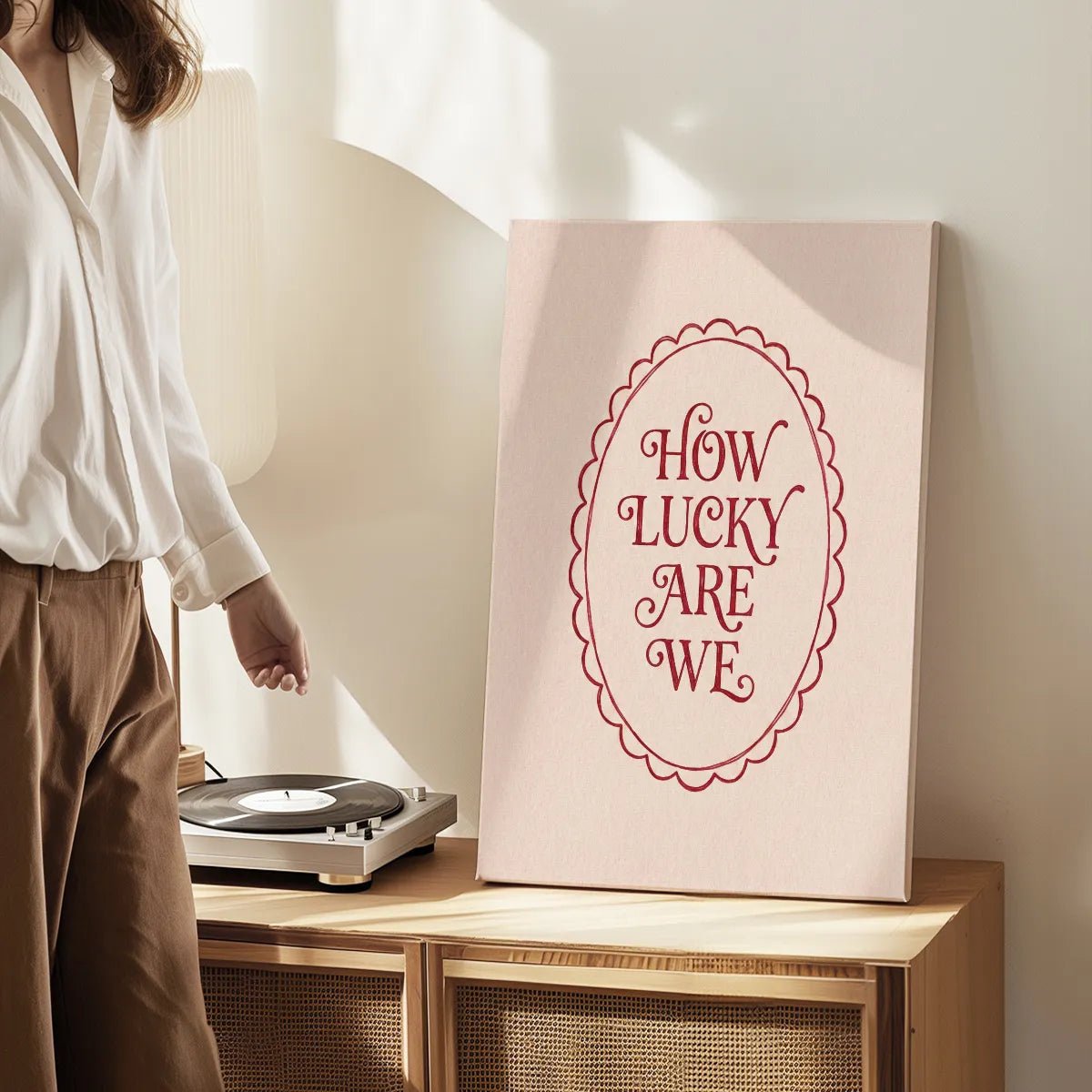 Gallery wrapped canvas featuring affectionate message in clean red font, framed by a scalloped oval on a beige field