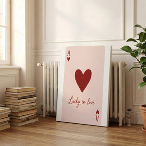 Canvas wall art print featuring a bold heart and letter A above cursive text, styled for modern romantic interiors.
