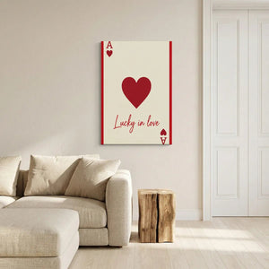 Modern canvas wall decor with a vertical layout, featuring a bold red heart and the phrase 'Lucky in love' in a high-contrast palette.