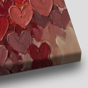 Textured canvas wall decor with thick oil brushstrokes forming a central heart composition in warm monochromatic colors.