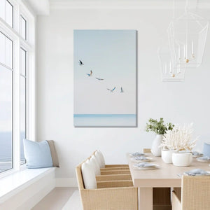 Birds in flight canvas print above ocean, perfect for sunny modern living room placement