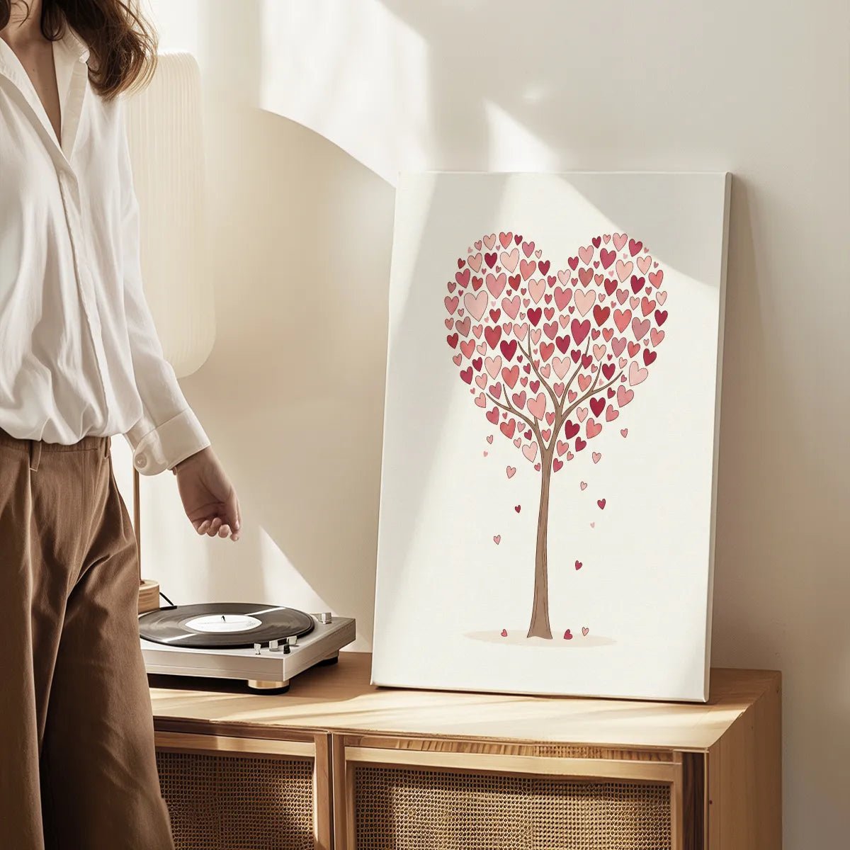 Modern canvas art with a clean-lined heart tree illustration in warm pinks and reds, evoking a light and romantic mood.