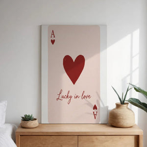 Decorative canvas print with a flat red heart and 'Lucky in love' text, ideal for romantic-themed bedroom decor.