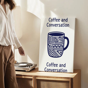 Canvas wall art print showing a geometric coffee mug and symmetrical text layout in a warm, inviting composition.