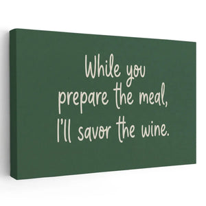 Canvas wall art featuring the phrase 'While you prepare the meal, I’ll savor the wine' in handwritten-style text on dark green background
