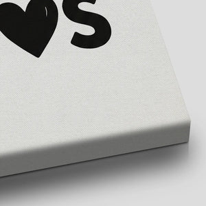 Decorative canvas print with clean, bold lettering and a heart icon, arranged in a balanced four-line composition.