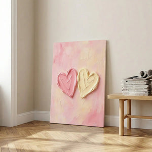 Modern canvas art showcasing thick acrylic textures forming two hearts on a light, impressionistic pastel background.