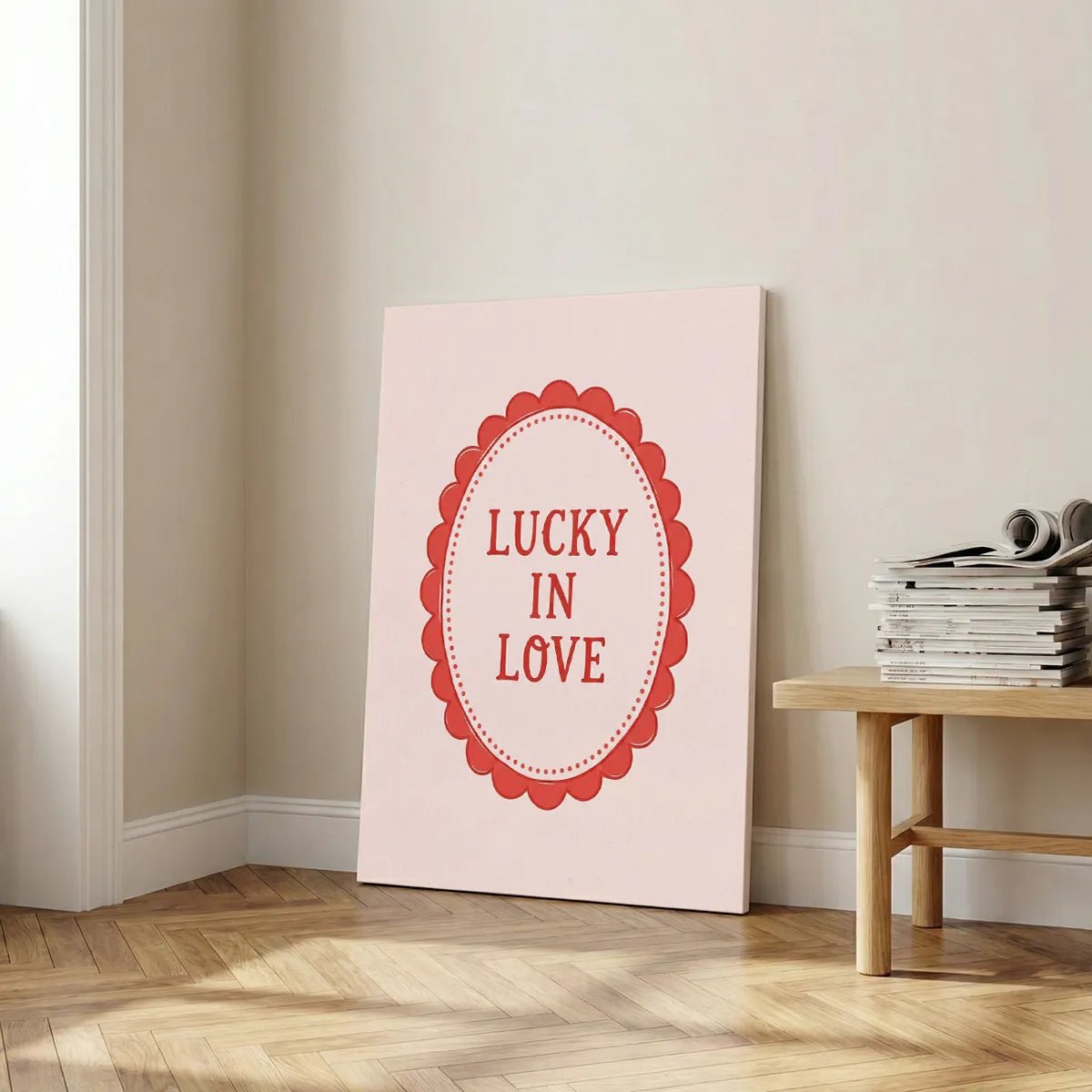 Fine art canvas featuring minimalist red text framed by a scalloped oval, styled for romantic-themed interiors