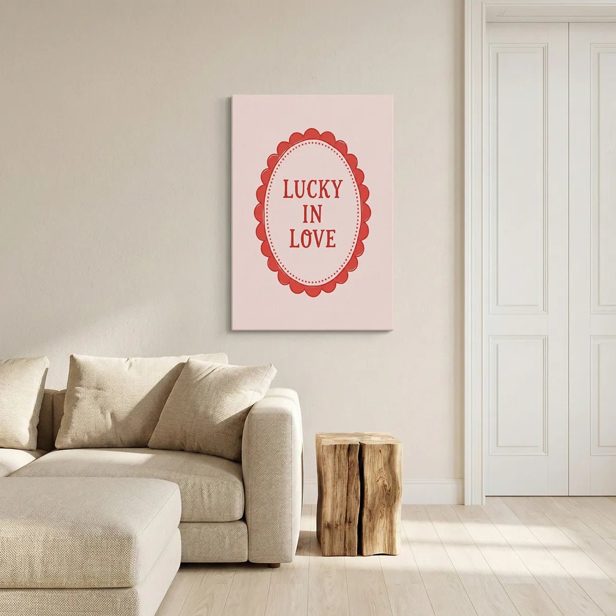 Flat graphic canvas print showing centered 'LUCKY IN LOVE' text within a dotted red oval on soft pink